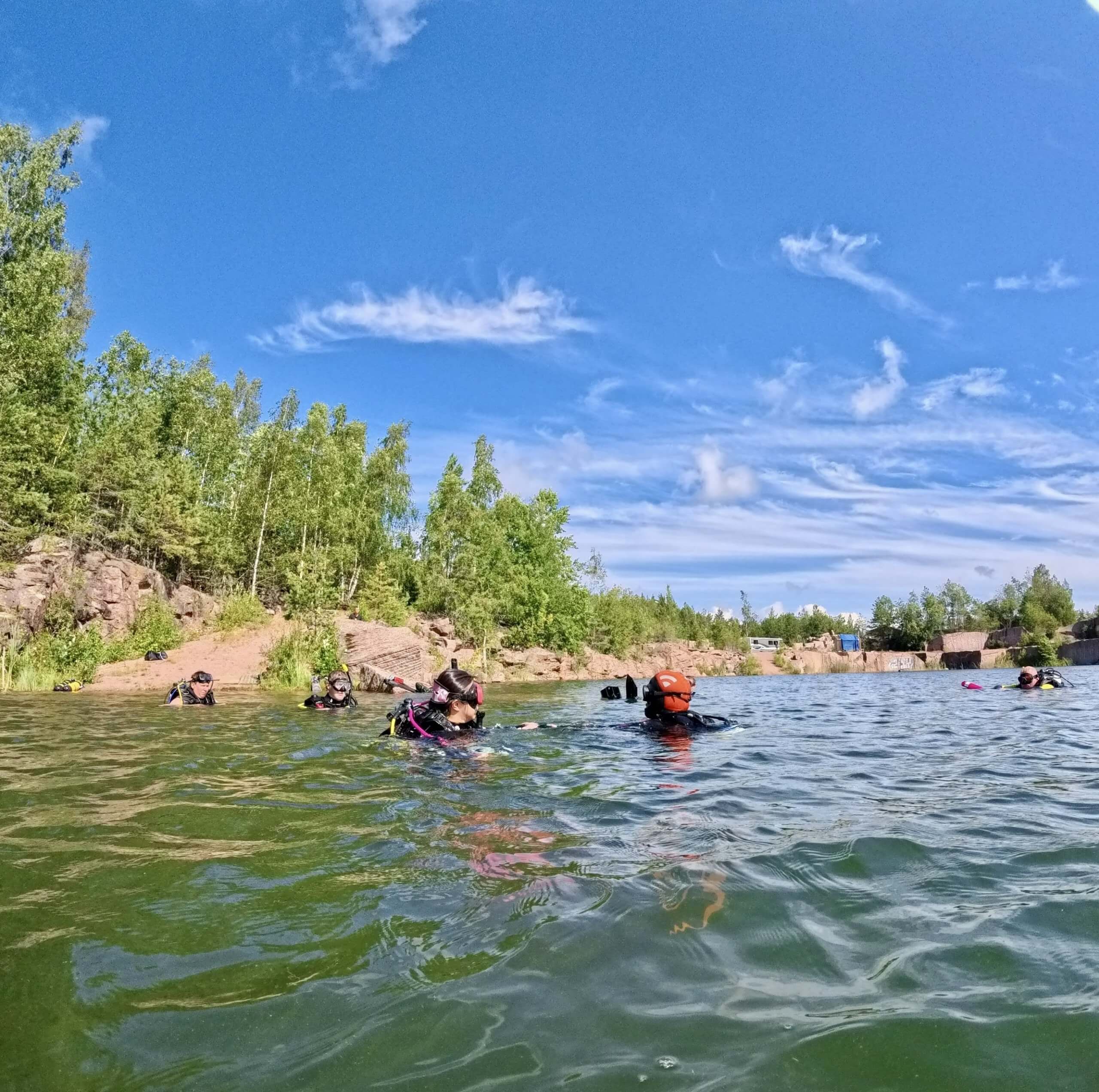 Scuba divers at the surface during a summer open water dive in Finland